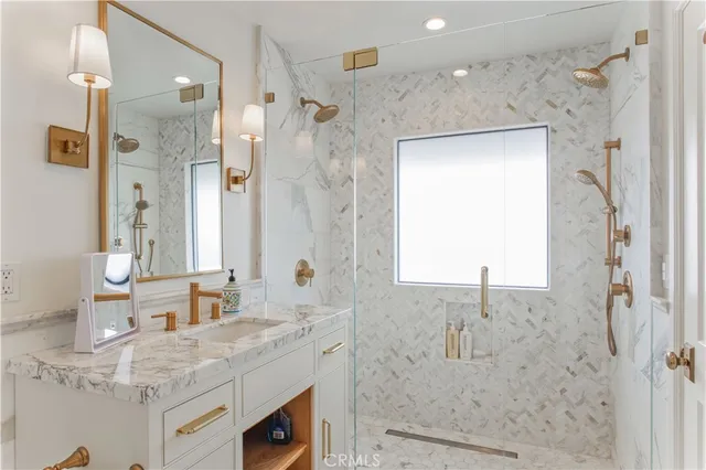 a bathroom with a granite countertop sink a shower and a mirror