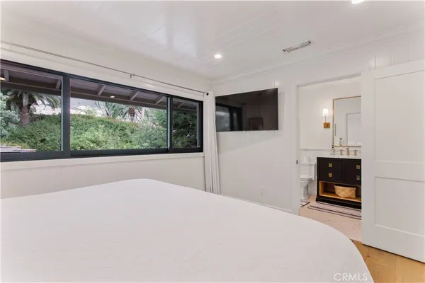 a bathroom with a granite countertop sink a toilet a mirror and shower