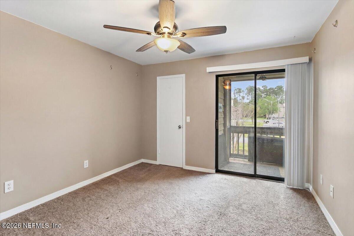 10200 Belle Rive Boulevard, Unit 66 Jacksonville, FL 32256 - Photo 12 of 18 an empty room with chandelier fan