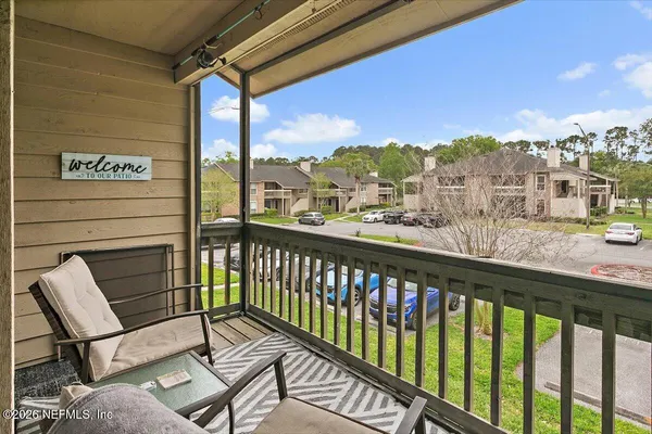 a view of a chairs and table in the balcony