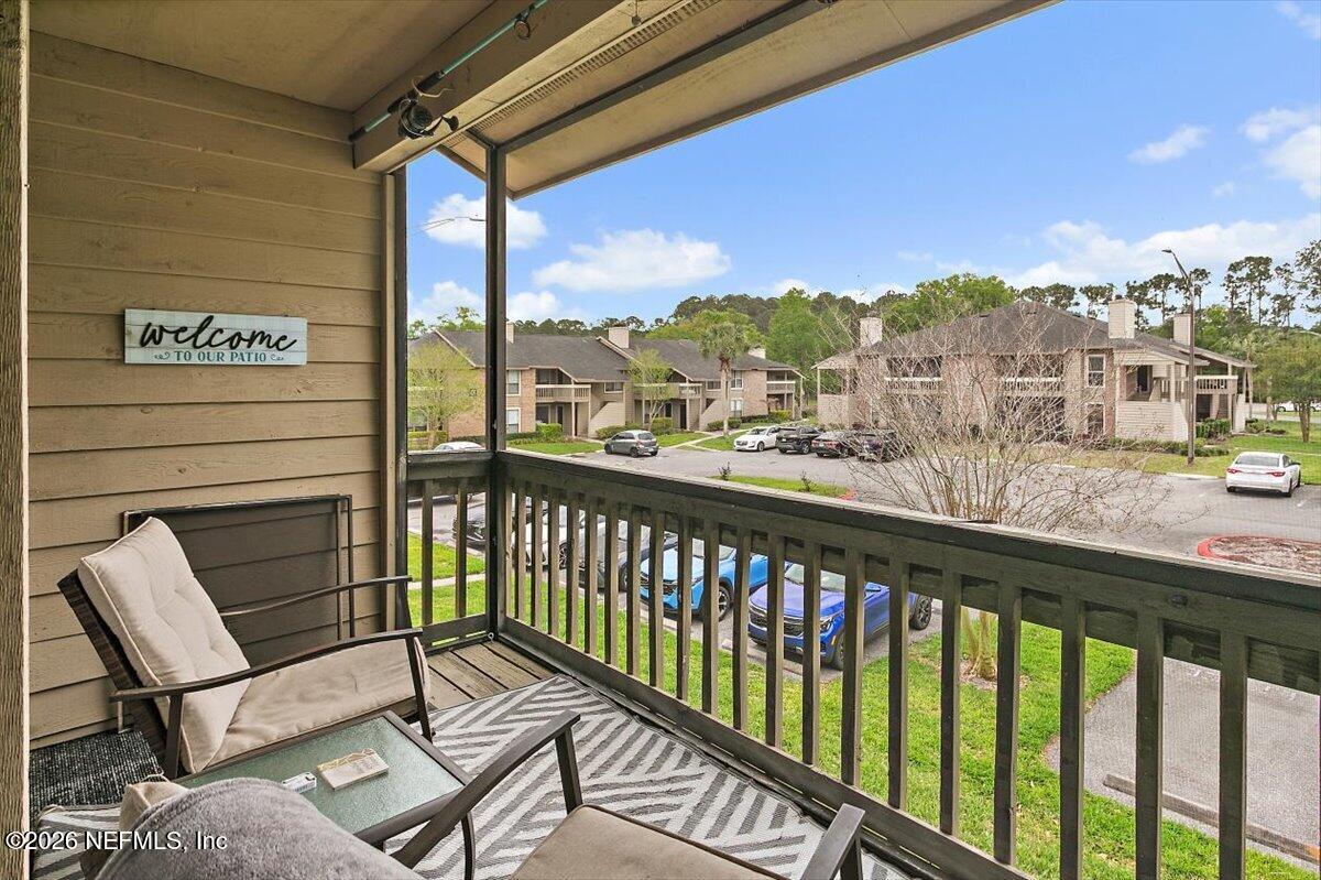 10200 Belle Rive Boulevard, Unit 66 Jacksonville, FL 32256 - Photo 14 of 18 a view of a chairs and table in the balcony