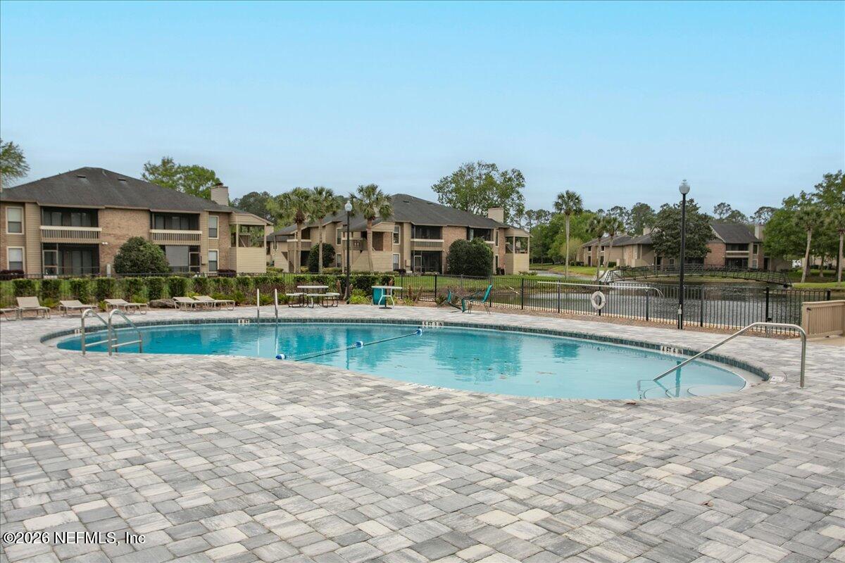 10200 Belle Rive Boulevard, Unit 66 Jacksonville, FL 32256 - Photo 15 of 18 a view of a swimming pool and outdoor space