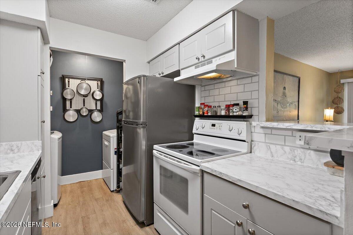 10200 Belle Rive Boulevard, Unit 66 Jacksonville, FL 32256 - Photo 2 of 18 a kitchen with stainless steel appliances granite countertop a refrigerator and a sink
