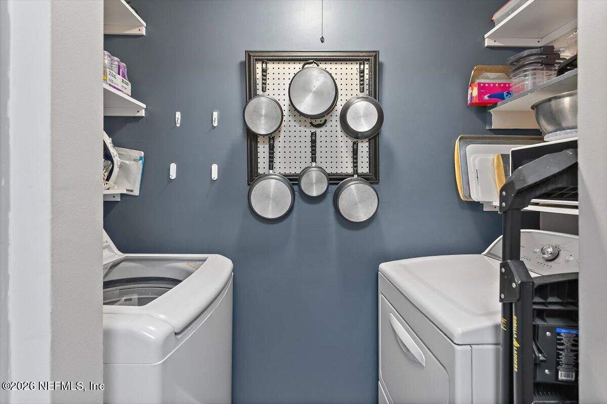 10200 Belle Rive Boulevard, Unit 66 Jacksonville, FL 32256 - Photo 4 of 18 a view of a storage and utility room with washer and dryer