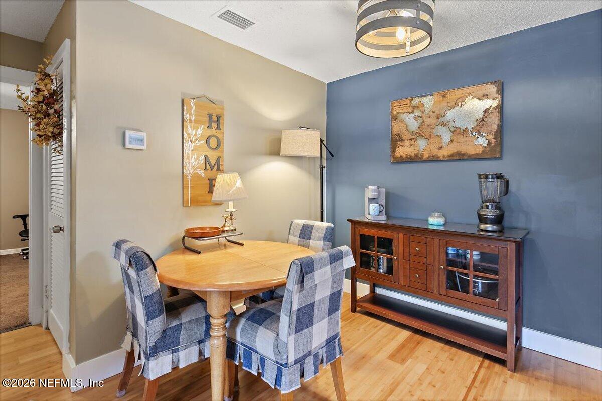 10200 Belle Rive Boulevard, Unit 66 Jacksonville, FL 32256 - Photo 5 of 18 a view of a dining room with furniture and a chandelier