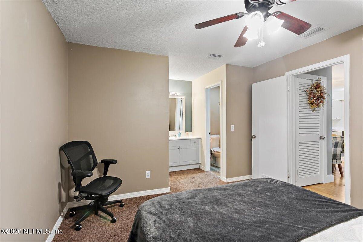10200 Belle Rive Boulevard, Unit 66 Jacksonville, FL 32256 - Photo 10 of 18 a bedroom with a workspace