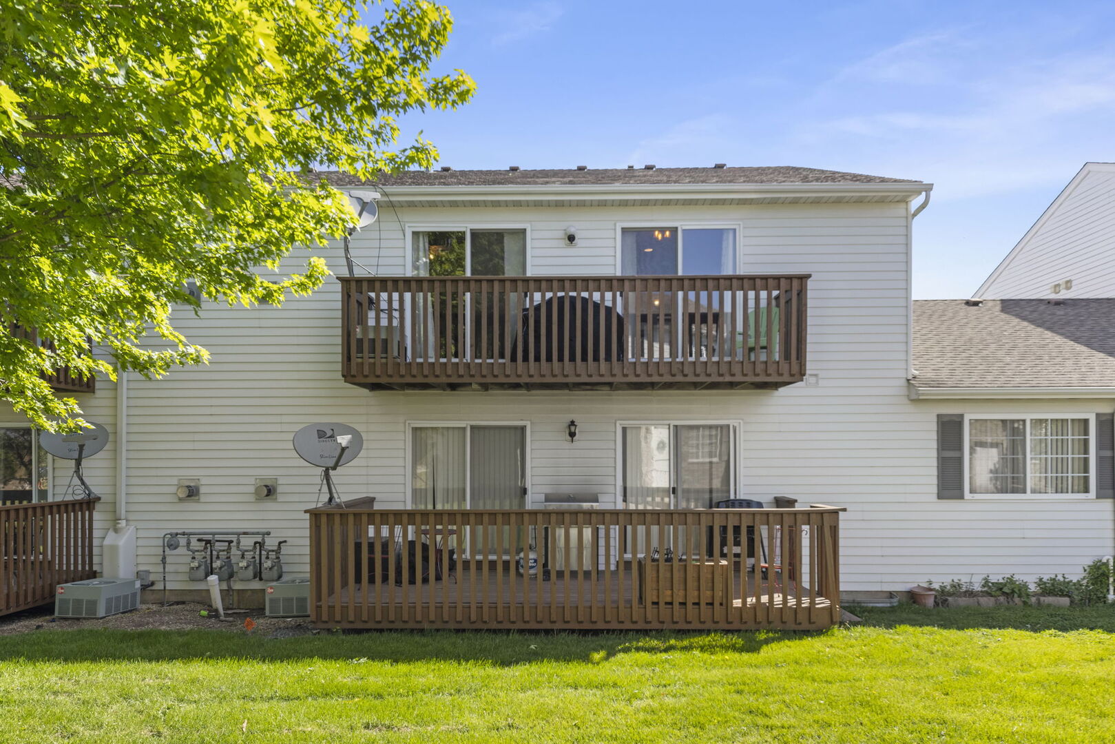 965 Constance Lane, Unit G Sycamore, IL 60178 - Photo 23 of 25 a view of a house with a deck and a yard