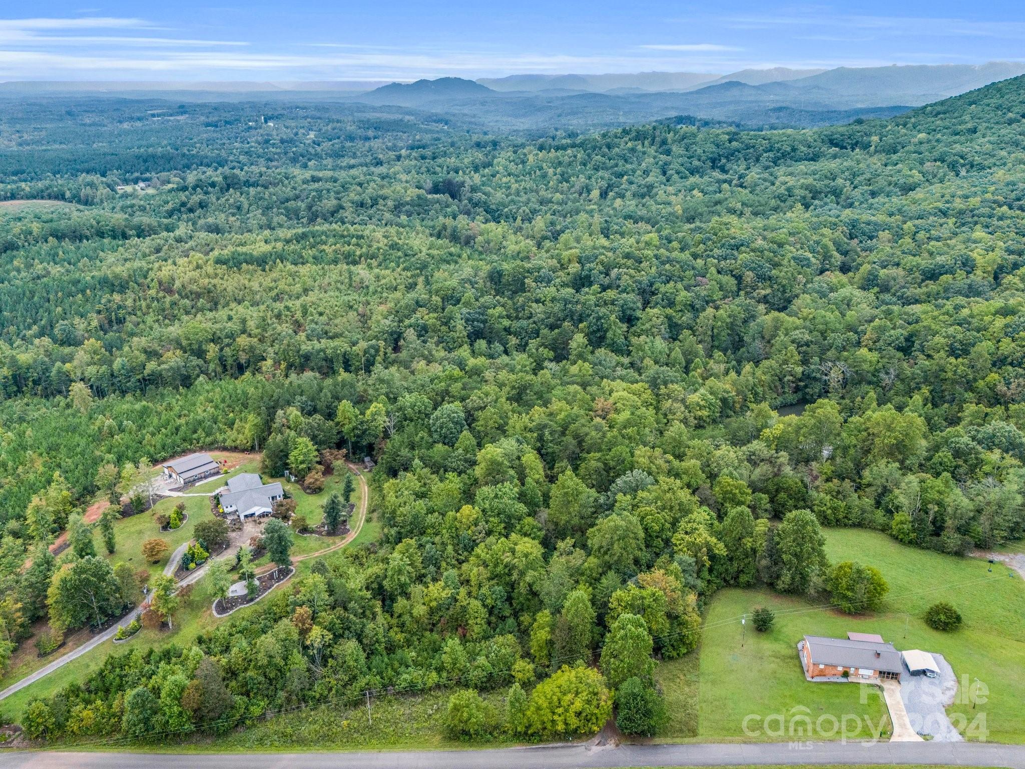 0 Padgett Road Union Mills, NC 28167 - Photo 13 of 20 a view of a lush green forest with trees and houses