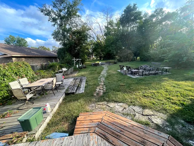 a view of a lake with couches and lounge chairs