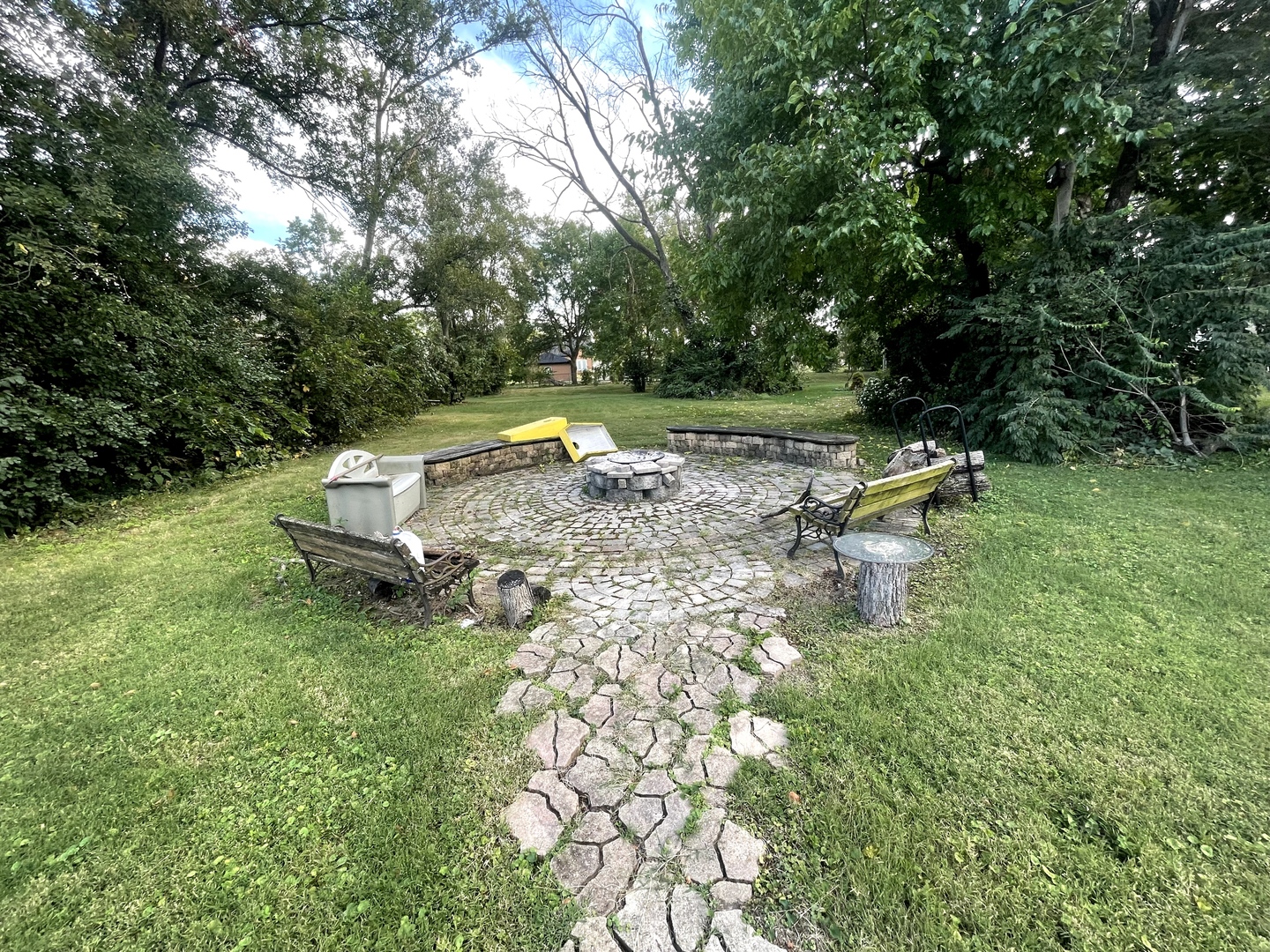 9803 West 57th Street Countryside, IL 60525 - Photo 13 of 13 a view of a swimming pool with a bench and lawn chairs under an umbrella