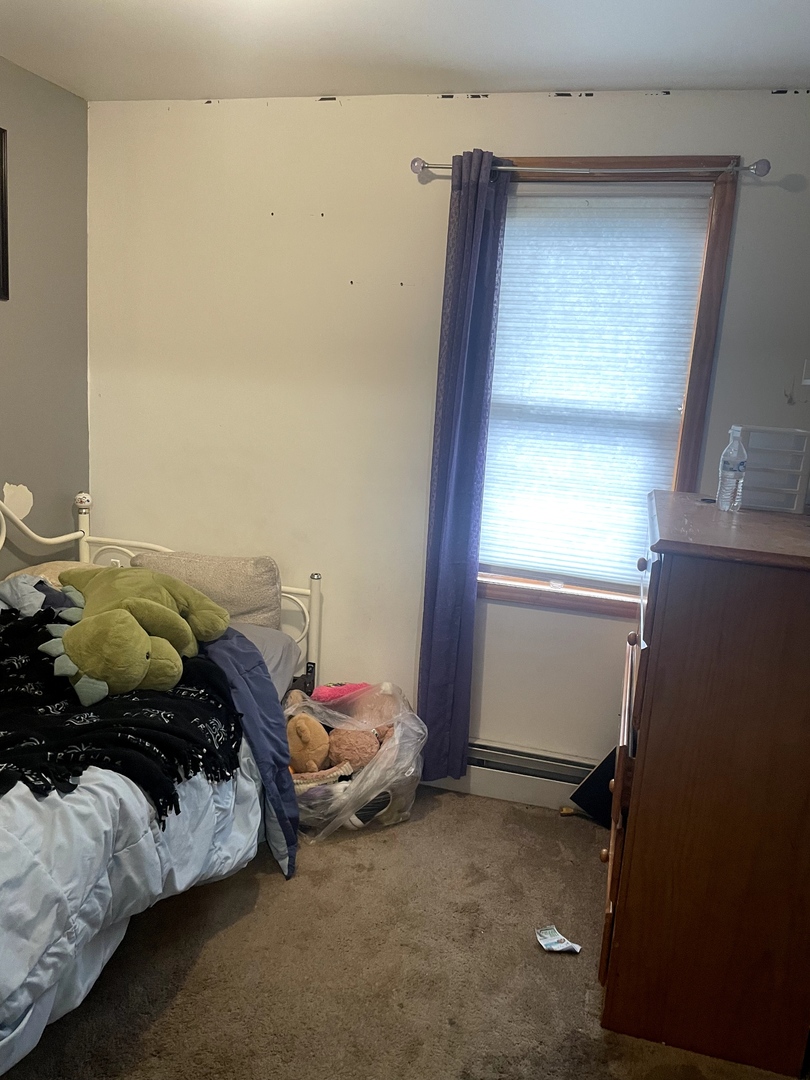 9803 West 57th Street Countryside, IL 60525 - Photo 5 of 13 a bed sitting in a bedroom next to a window