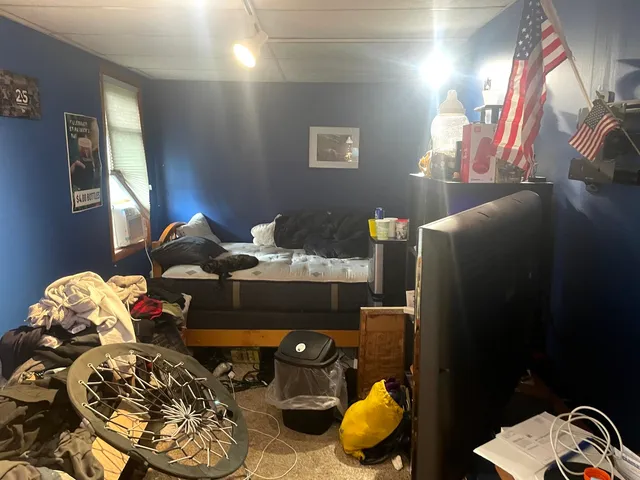 a bedroom with a bed and a chandelier