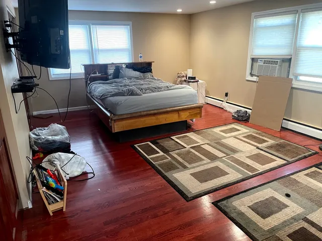 a bedroom with furniture and a book shelf