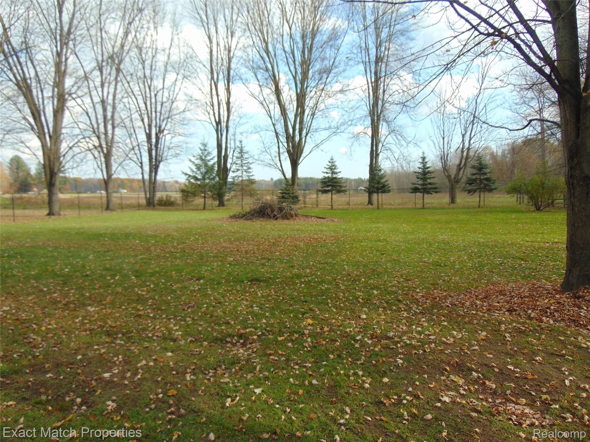 4886 North Stark Road Hope, MI 48628 - Photo 13 of 16 Large Fenced in Backyard with plenty of Mature Trees....
