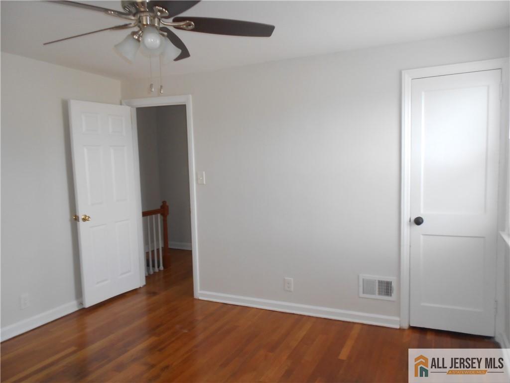 431 Crows Mill Road Fords, NJ 08863 - Photo 11 of 20 an empty room with wooden floor closet and windows