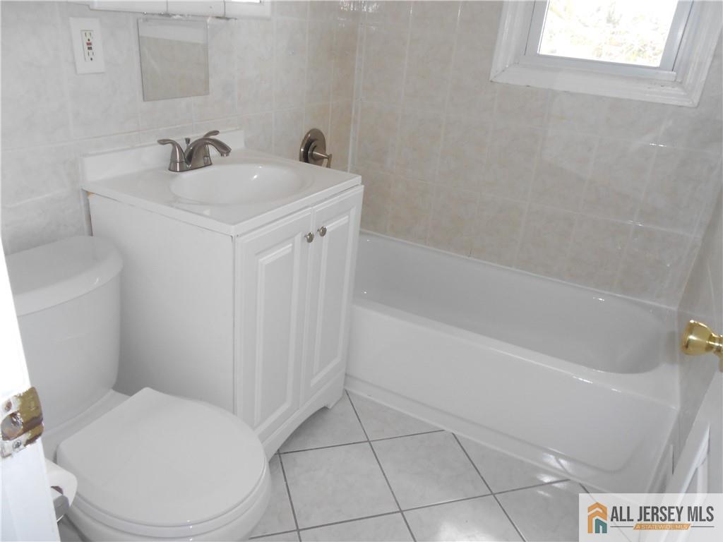 431 Crows Mill Road Fords, NJ 08863 - Photo 14 of 20 a bathroom with a sink a toilet and shower