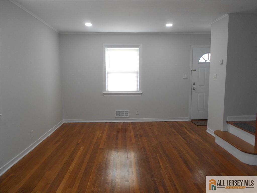 431 Crows Mill Road Fords, NJ 08863 - Photo 3 of 20 an empty room with wooden floor and windows