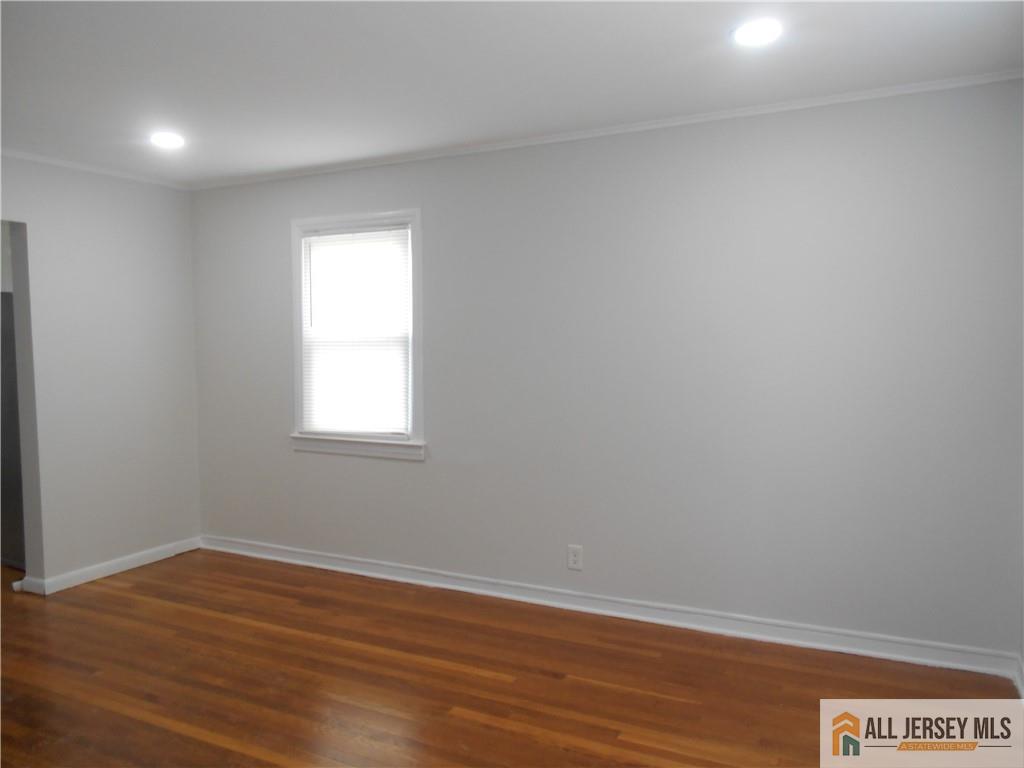 431 Crows Mill Road Fords, NJ 08863 - Photo 4 of 20 a view of an empty room with wooden floor and a window