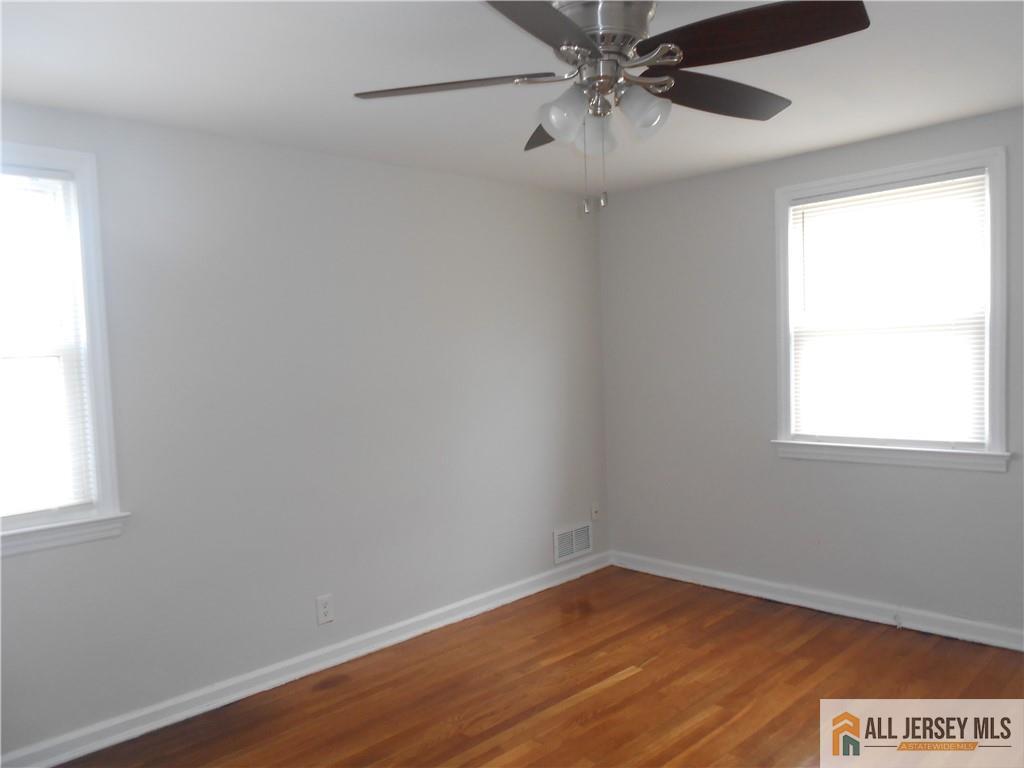 431 Crows Mill Road Fords, NJ 08863 - Photo 10 of 20 wooden floor in an empty room with a window