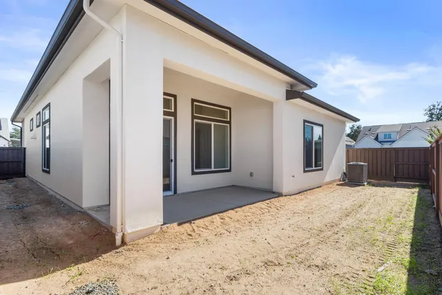 a view of a house with a wooden fence