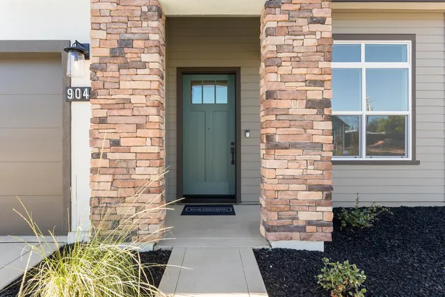 a front view of a house with a garden