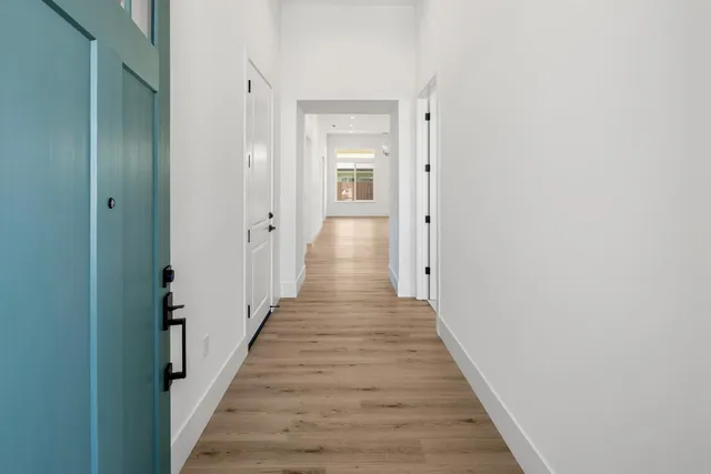 a view of a hallway with wooden floor and staircase