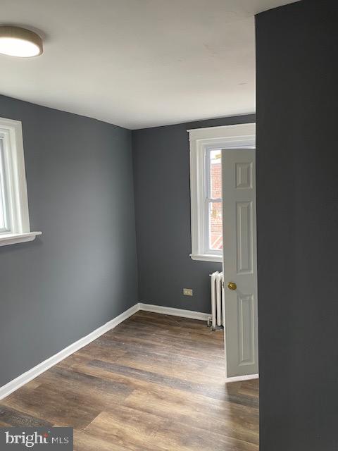 7117 Atlantic Avenue Upper Darby, PA 19082 - Photo 14 of 17 an empty room with wooden floor and windows