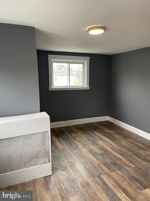 7117 Atlantic Avenue Upper Darby, PA 19082 - Photo 17 of 17 a view of an empty room with wooden floor and a window