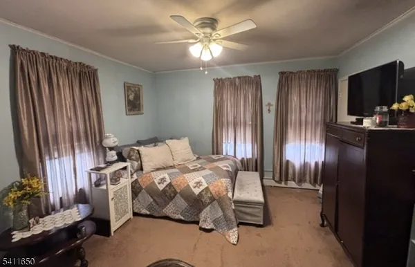 a bedroom with furniture and a flat screen tv