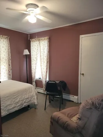 a bedroom with a bed and a chair