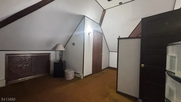 a view of hallway with stairs and wooden floor