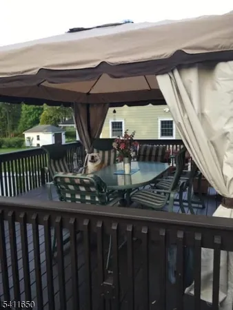 a view of a wooden deck with a yard