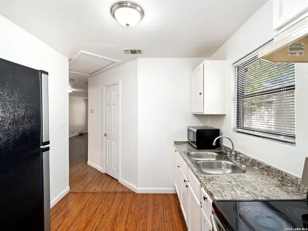 a kitchen with a sink stove and cabinets
