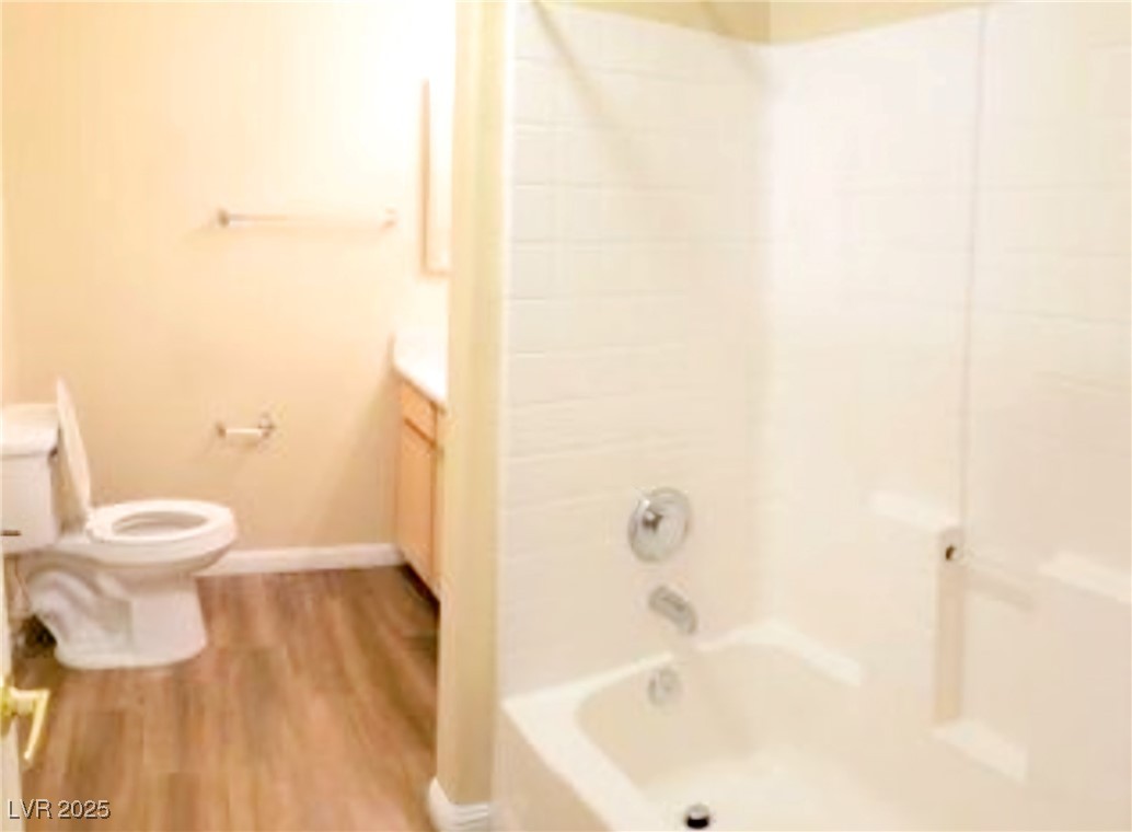1830 North Pecos Road, Unit 131 Las Vegas, NV 89115 - Photo 10 of 13 Full bathroom featuring wood finished floors, vanity, tub / shower combination, baseboards, and toilet
