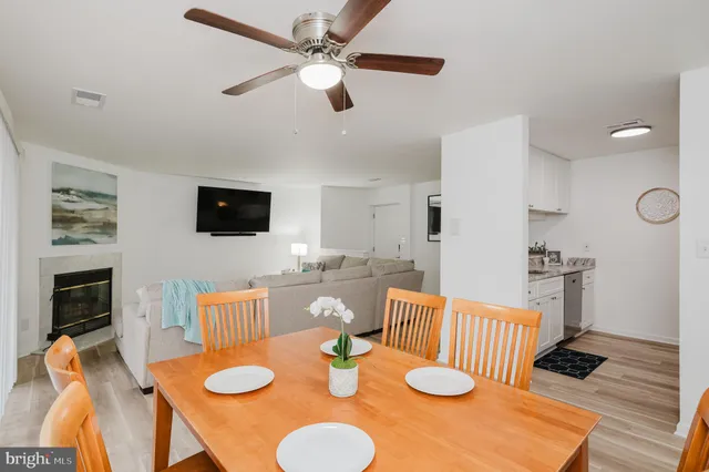 a view of a dining room with furniture a chandelier and wooden floor