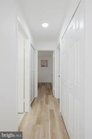 a view of a hallway with wooden floor