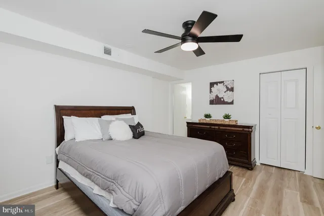 a bedroom with a bed and painting on the wall