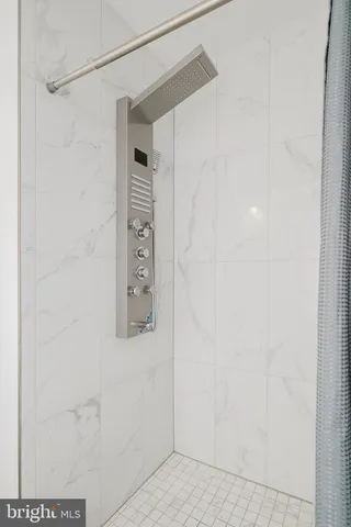 a bathroom with a shower and a sink