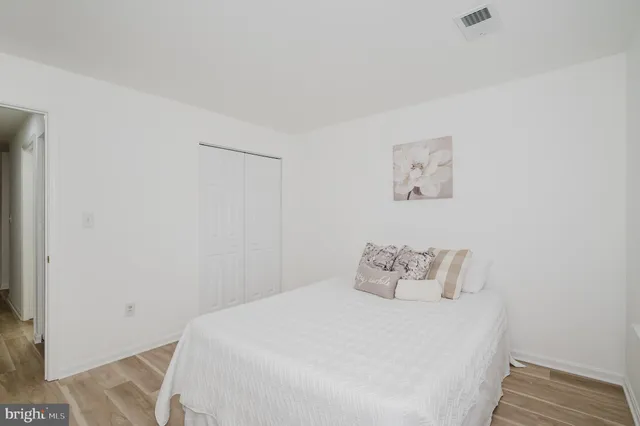 a bedroom with a bed and a wall painting