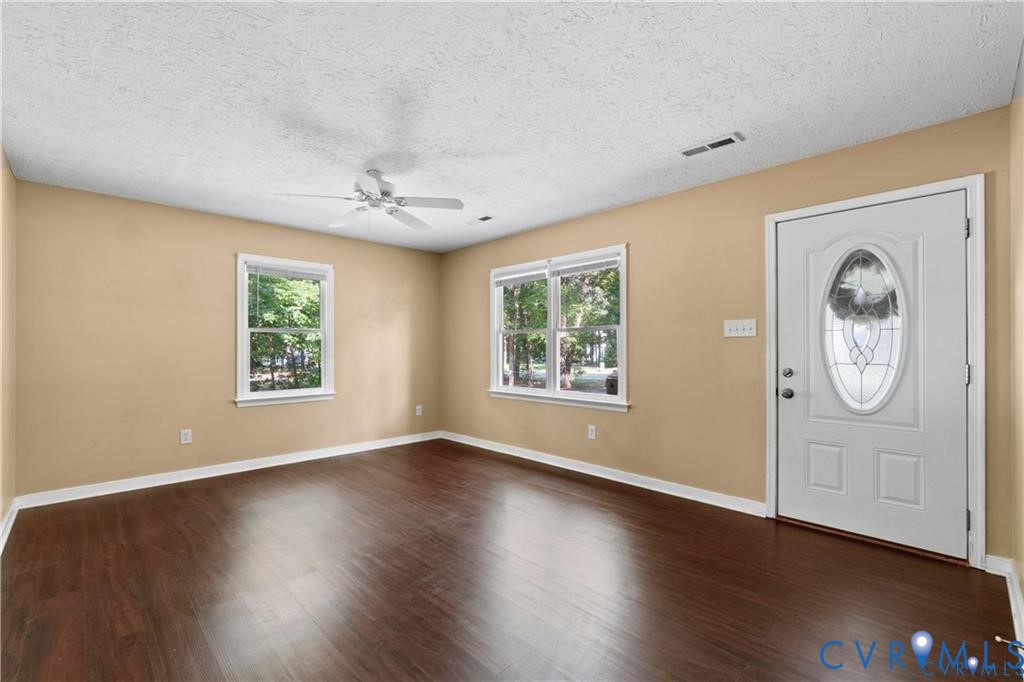 337 Corann Drive Aylett, VA 23009 - Photo 4 of 5 a view of an empty room with a window and wooden floor
