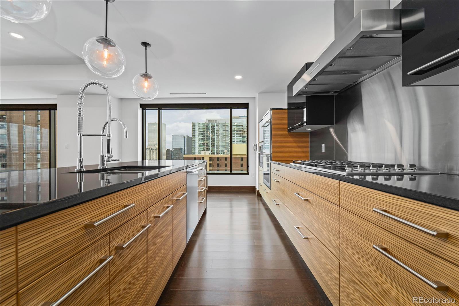 1133 14th Street, Unit 2620 Denver, CO 80202 - Photo 12 of 43 a large kitchen with stainless steel appliances and large windows