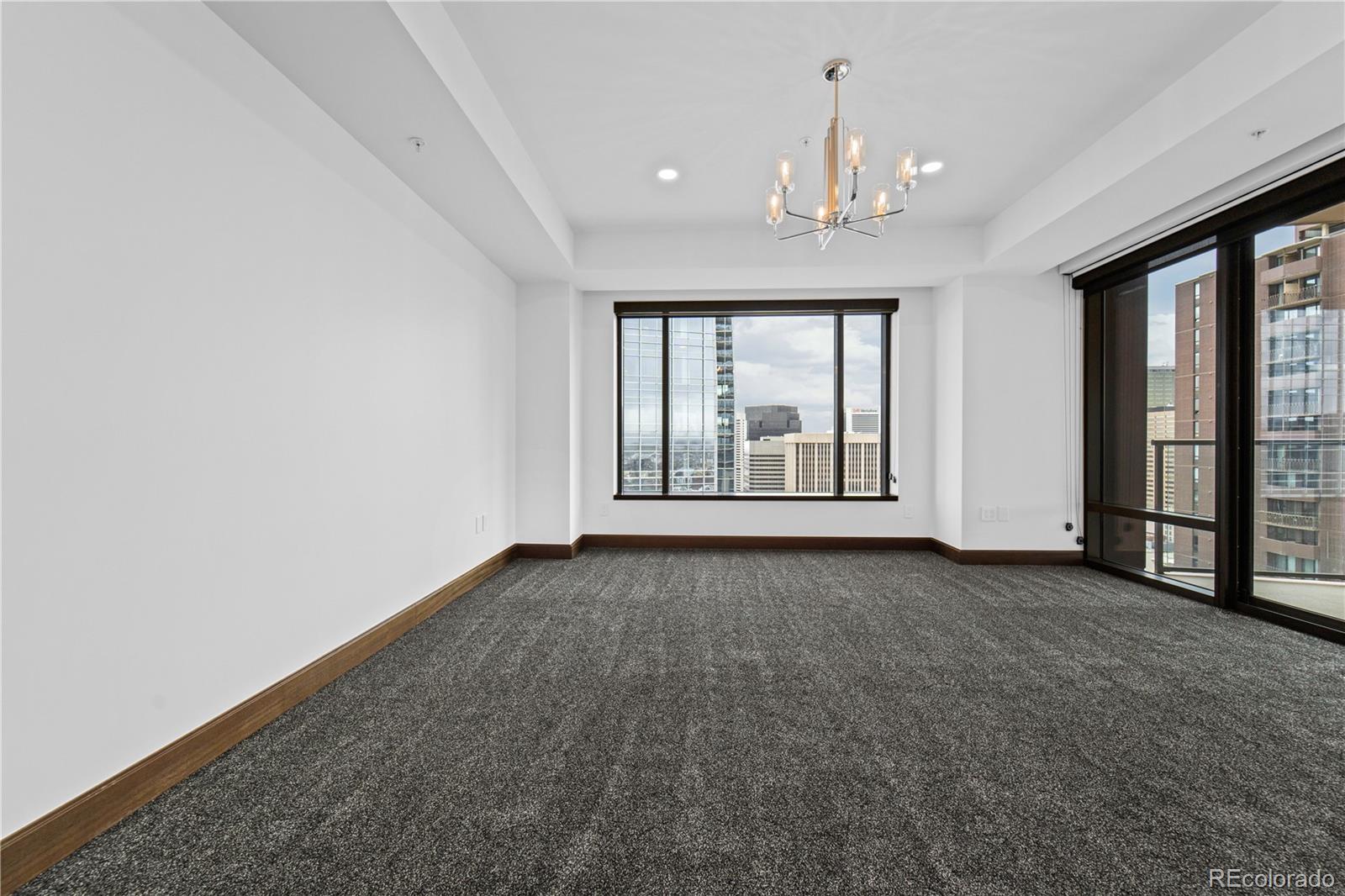 1133 14th Street, Unit 2620 Denver, CO 80202 - Photo 13 of 43 an empty room with chandelier fan and windows