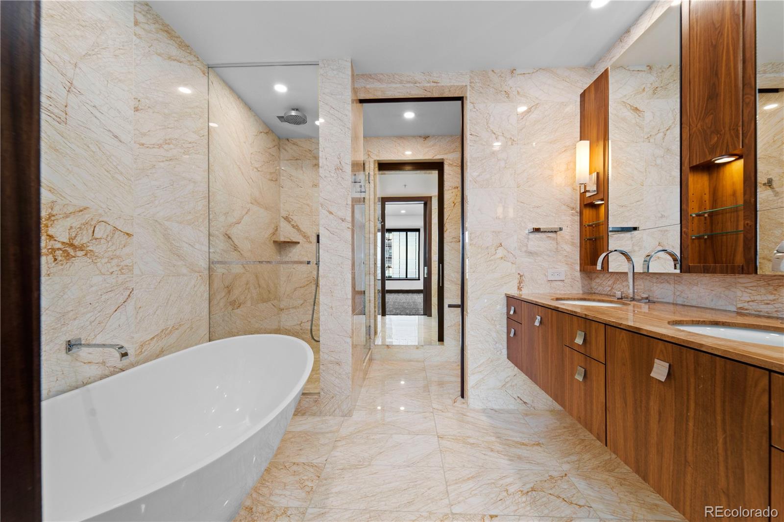 1133 14th Street, Unit 2620 Denver, CO 80202 - Photo 17 of 43 a spacious bathroom with a tub shower a sink and mirror