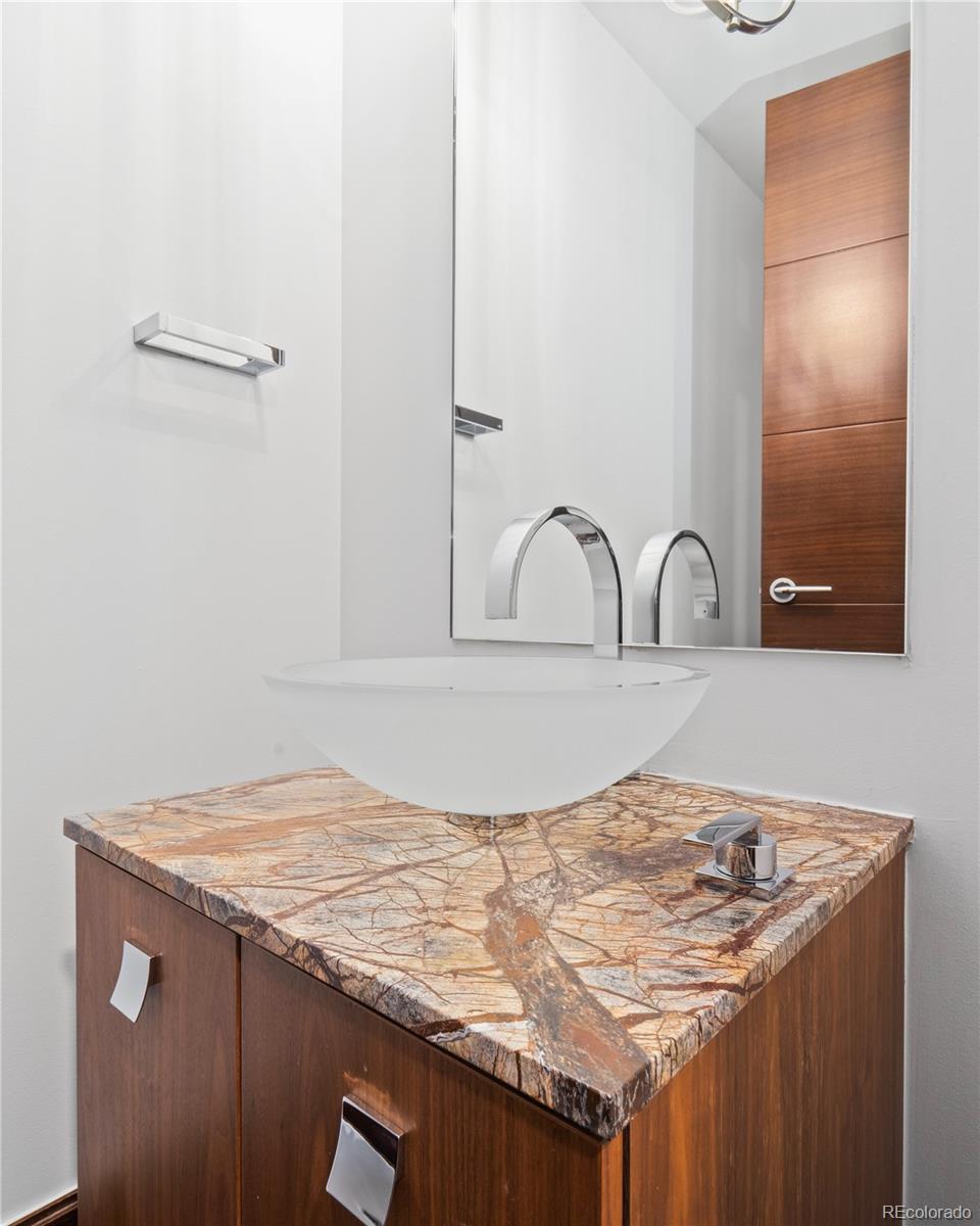 1133 14th Street, Unit 2620 Denver, CO 80202 - Photo 21 of 43 a bathroom with a granite countertop sink and white cabinets