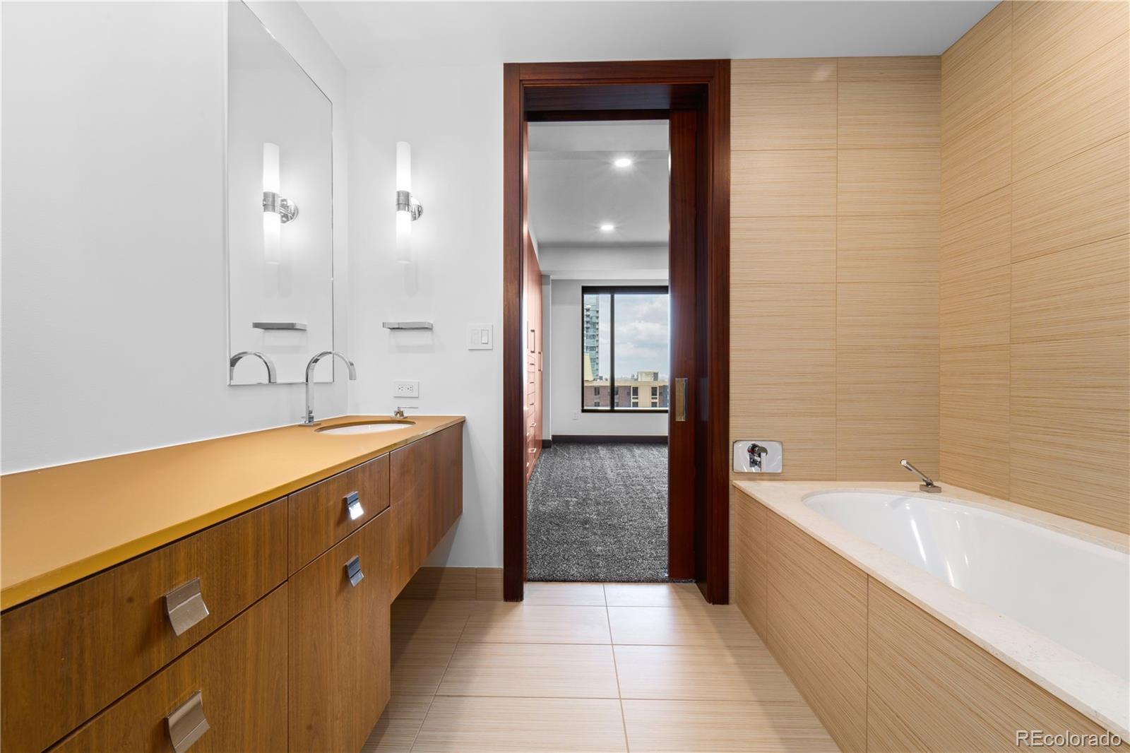 1133 14th Street, Unit 2620 Denver, CO 80202 - Photo 25 of 43 a spacious bathroom with a tub sink and mirror