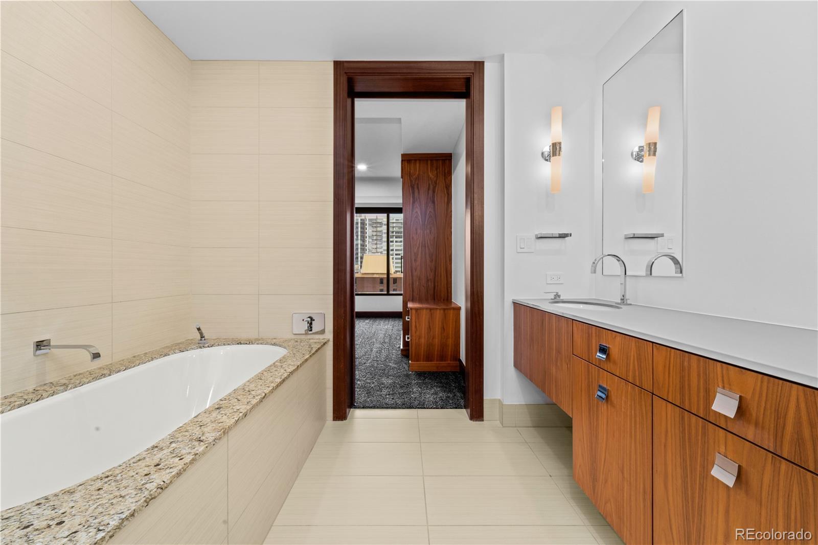 1133 14th Street, Unit 2620 Denver, CO 80202 - Photo 30 of 43 a spacious bathroom with a tub sink and mirror