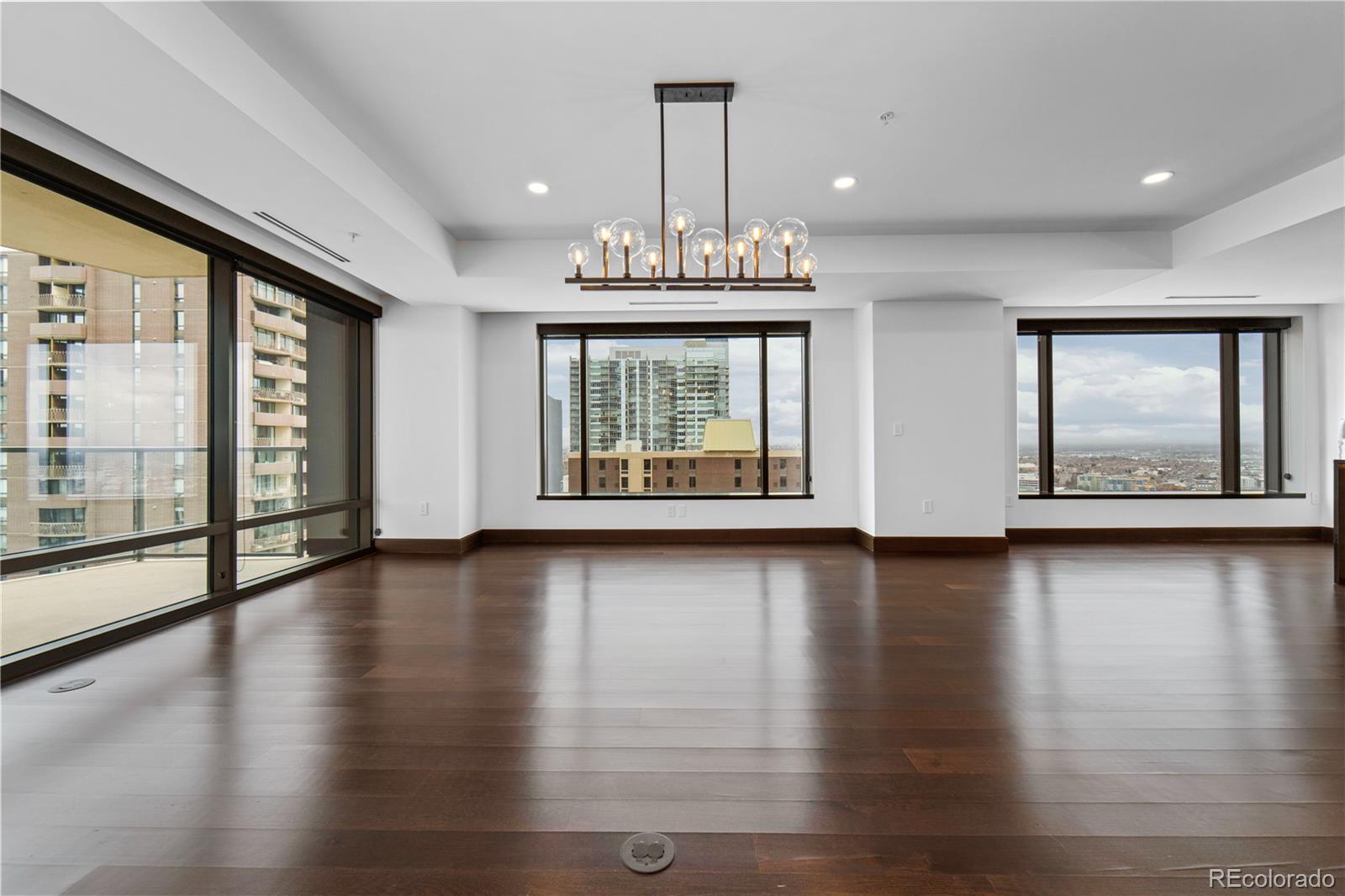 1133 14th Street, Unit 2620 Denver, CO 80202 - Photo 7 of 43 an empty room with wooden floor and windows