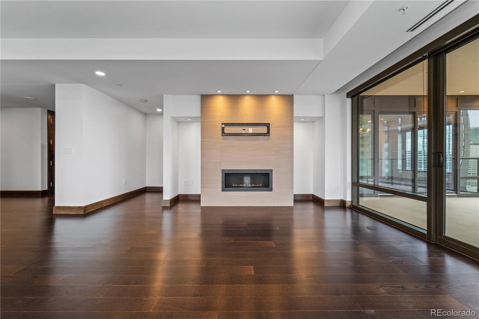 1133 14th Street, Unit 2620 Denver, CO 80202 - Photo 8 of 43 a view of an empty room with wooden floor and a fireplace