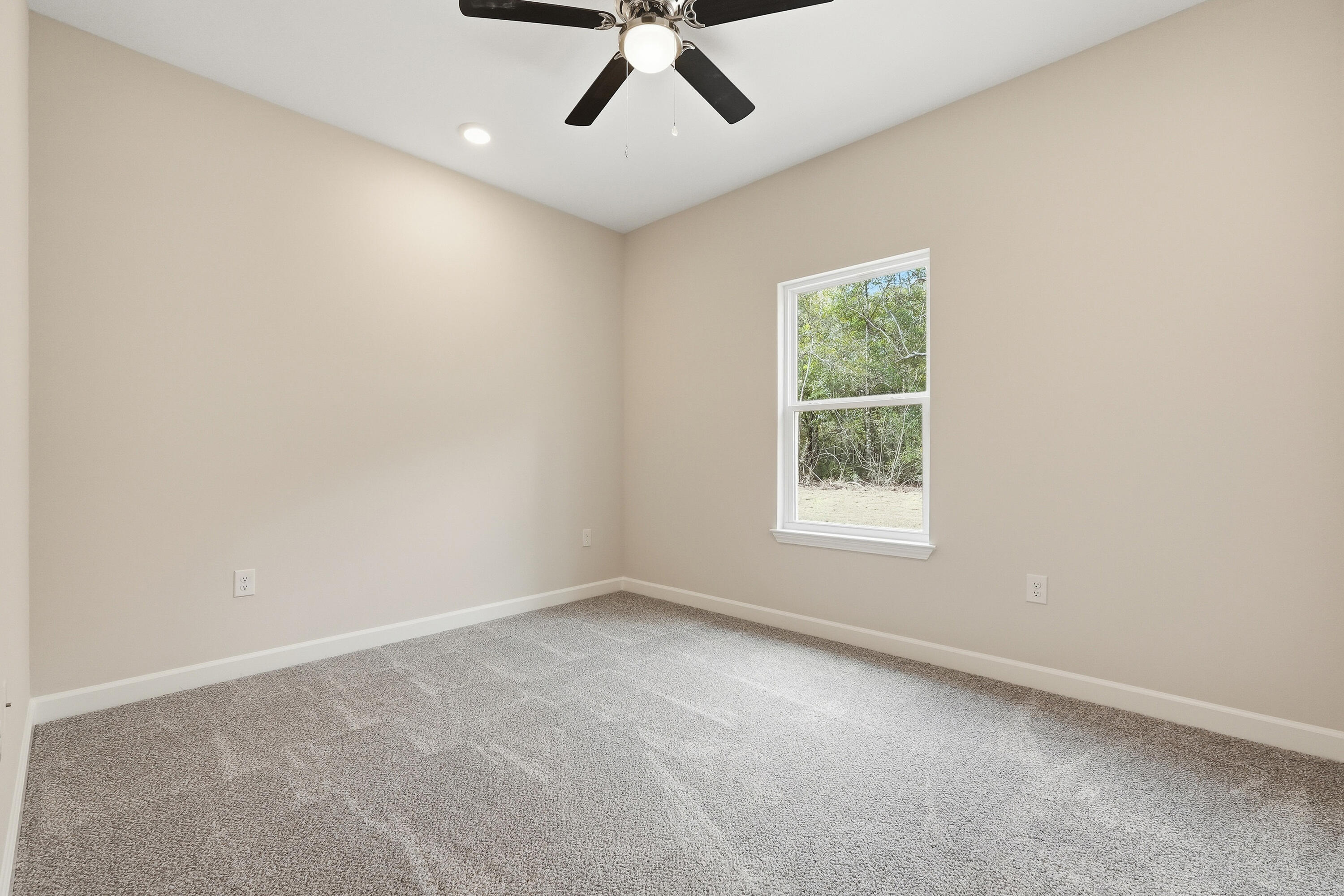 6106 Mildred's Way Crestview, FL 32539 - Photo 21 of 31 an empty room with a window and a ceiling fan