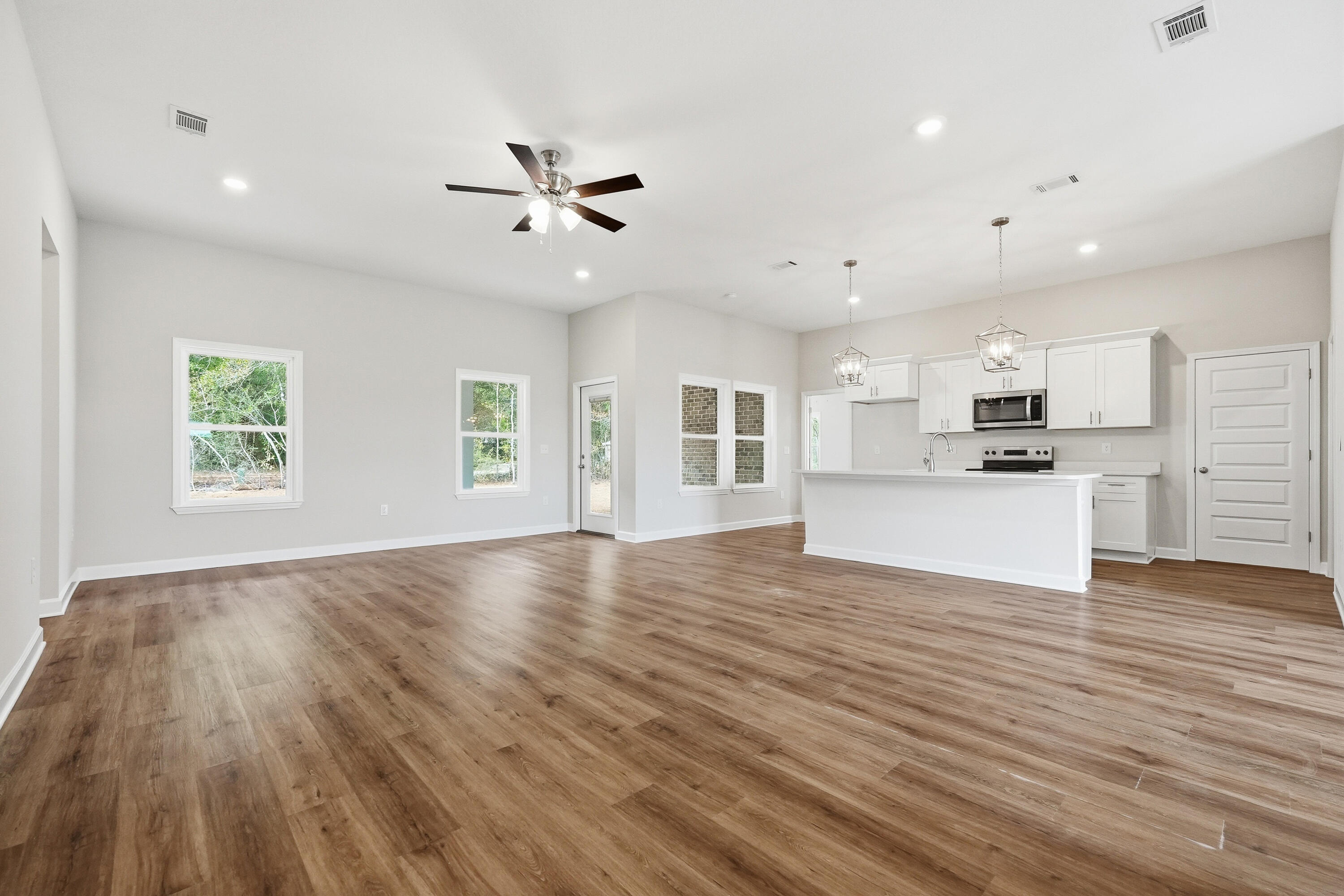 6106 Mildred's Way Crestview, FL 32539 - Photo 3 of 31 a view of a kitchen with wooden floor and a kitchen